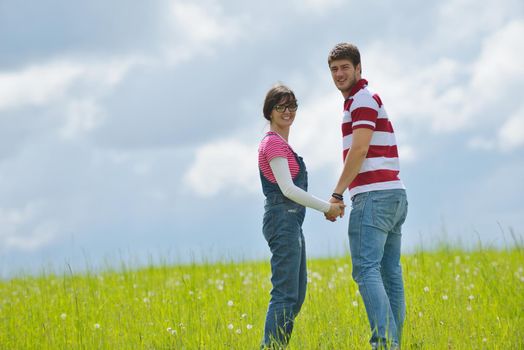 Portrait of romantic young couple in love  smiling together outdoor in nature with blue sky in background