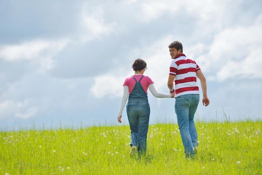 Portrait of romantic young couple in love  smiling together outdoor in nature with blue sky in background