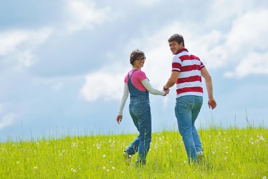 Portrait of romantic young couple in love  smiling together outdoor in nature with blue sky in background