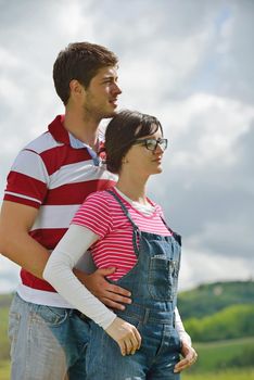 Portrait of romantic young couple in love  smiling together outdoor in nature with blue sky in background