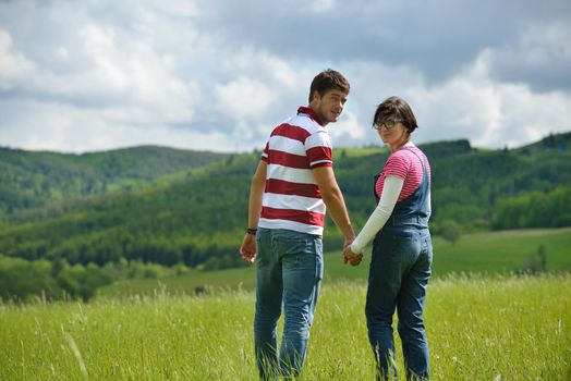 Portrait of romantic young couple in love  smiling together outdoor in nature with blue sky in background