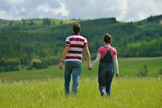 Portrait of romantic young couple in love  smiling together outdoor in nature with blue sky in background