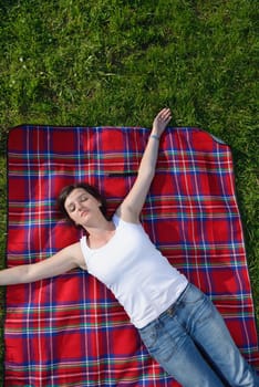 Enjoying the nature and life. Young woman arms raised enjoying the fresh air in green nature