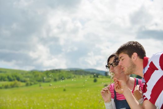 Portrait of romantic young couple in love  smiling together outdoor in nature with blue sky in background