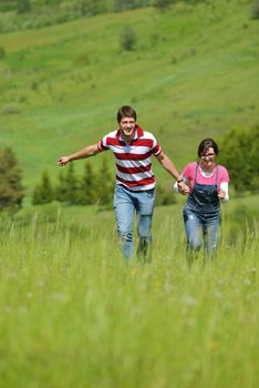 Portrait of romantic young couple in love  smiling together outdoor in nature with blue sky in background