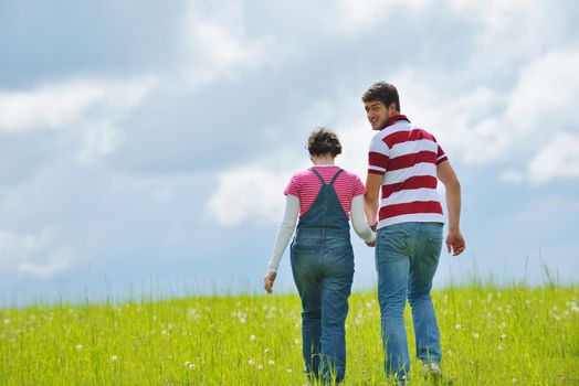 Portrait of romantic young couple in love  smiling together outdoor in nature with blue sky in background