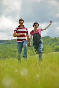 Portrait of romantic young couple in love  smiling together outdoor in nature with blue sky in background