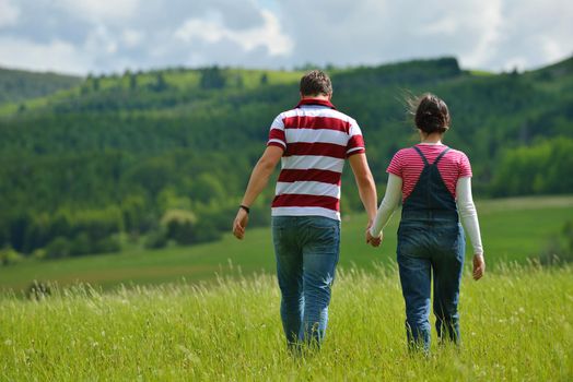 Portrait of romantic young couple in love  smiling together outdoor in nature with blue sky in background