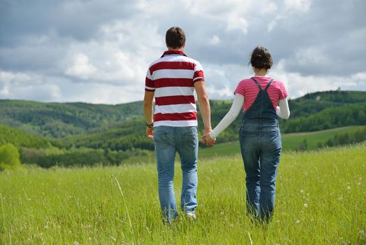 Portrait of romantic young couple in love  smiling together outdoor in nature with blue sky in background