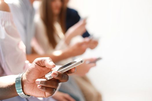 Group of students watching smartphones. Young people addiction to new technology trends.