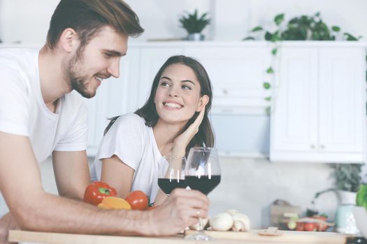 Beautiful young couple preparing a healthy meal together while spending free time at home.