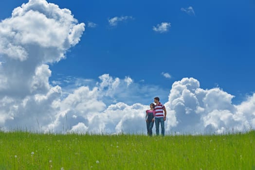 Portrait of romantic young couple in love  smiling together outdoor in nature with blue sky in background