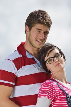 Portrait of romantic young couple in love  smiling together outdoor in nature with blue sky in background