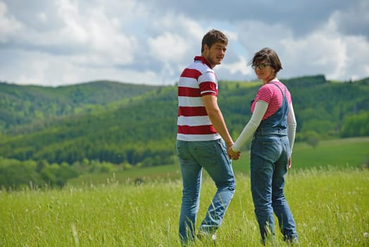 Portrait of romantic young couple in love  smiling together outdoor in nature with blue sky in background