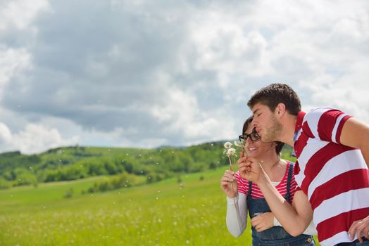 Portrait of romantic young couple in love  smiling together outdoor in nature with blue sky in background