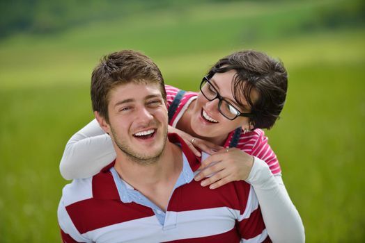 Portrait of romantic young couple in love  smiling together outdoor in nature with blue sky in background