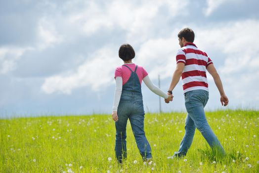 Portrait of romantic young couple in love  smiling together outdoor in nature with blue sky in background