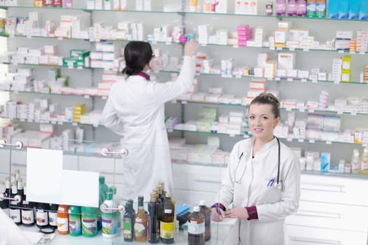 team of  pharmacist chemist woman group  standing in pharmacy drugstore