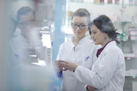 team of  pharmacist chemist woman group  standing in pharmacy drugstore