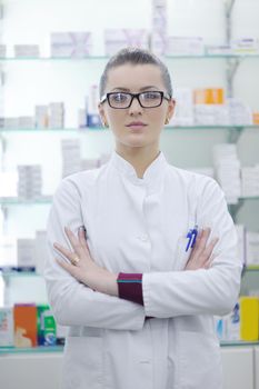 Happy cheerful pharmacist chemist woman standing in pharmacy drugstore