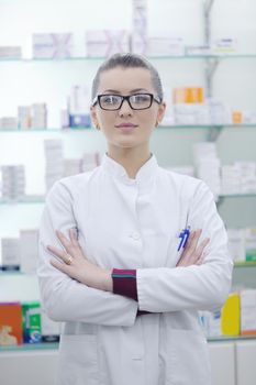 Happy cheerful pharmacist chemist woman standing in pharmacy drugstore