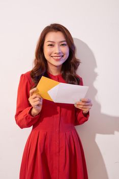 Young beautiful woman looking Invitation card and smile