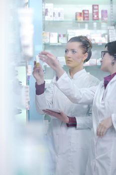 team of  pharmacist chemist woman group  standing in pharmacy drugstore