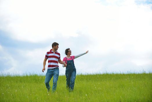 Portrait of romantic young couple in love  smiling together outdoor in nature with blue sky in background