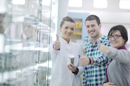 young pharmacist suggesting medical drug to buyer in pharmacy drugstore