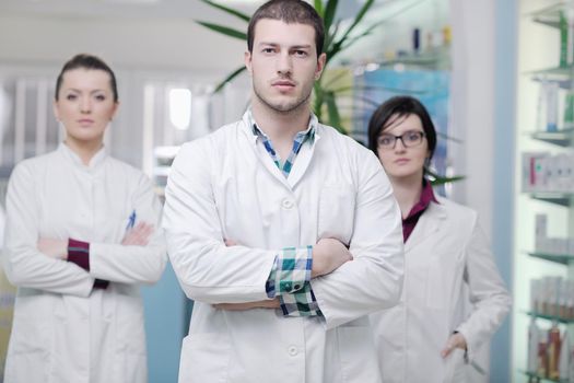 team of  pharmacist chemist woman and man  group  standing in pharmacy drugstore