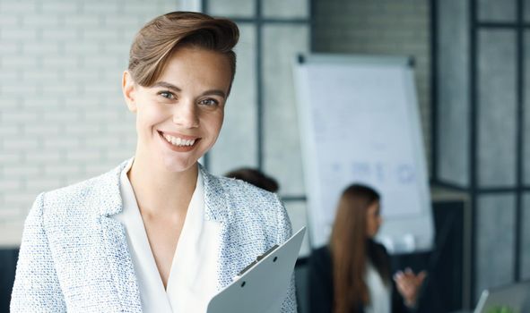 business woman with her staff, people group in background at modern bright office indoors