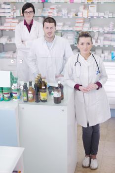 team of  pharmacist chemist woman and man  group  standing in pharmacy drugstore