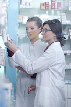 team of  pharmacist chemist woman group  standing in pharmacy drugstore