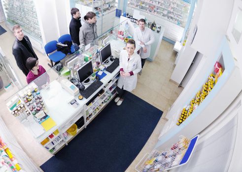 young pharmacist suggesting medical drug to buyer in pharmacy drugstore