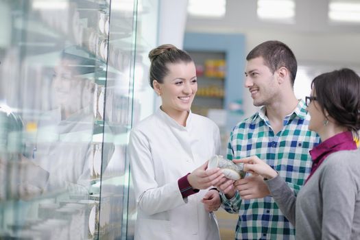 young pharmacist suggesting medical drug to buyer in pharmacy drugstore