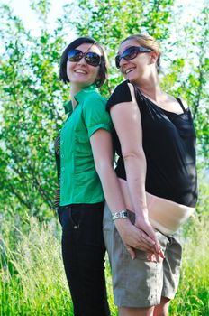 woman pragnant outdoor with friend smile and joy