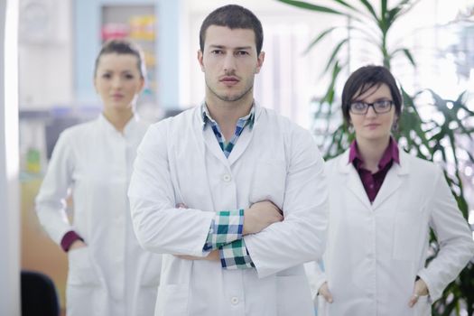 team of  pharmacist chemist woman and man  group  standing in pharmacy drugstore