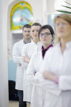 team of  pharmacist chemist woman and man  group  standing in pharmacy drugstore