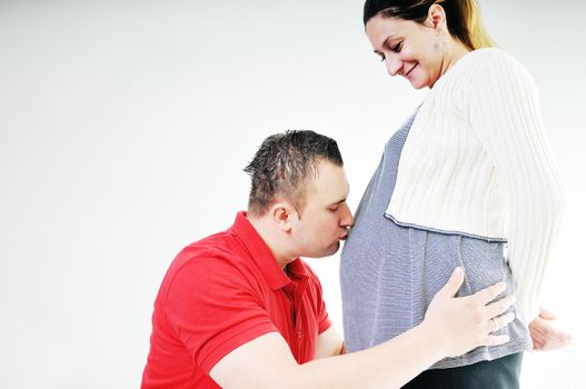 young family couple together in studio isolated on white. happy and waiting for baby