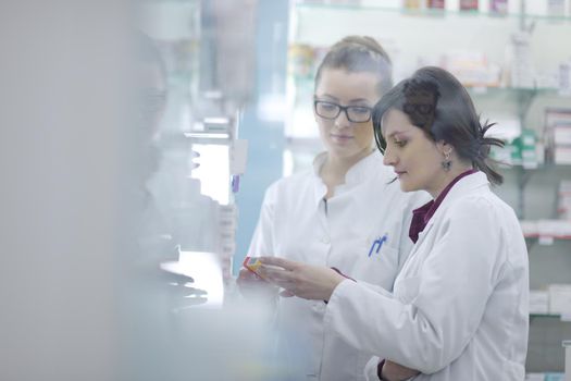 team of  pharmacist chemist woman group  standing in pharmacy drugstore