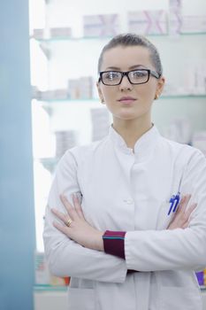 Happy cheerful pharmacist chemist woman standing in pharmacy drugstore