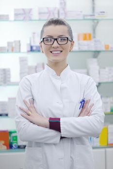 Happy cheerful pharmacist chemist woman standing in pharmacy drugstore