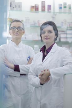 team of  pharmacist chemist woman group  standing in pharmacy drugstore