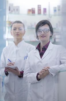 team of  pharmacist chemist woman group  standing in pharmacy drugstore