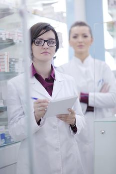 team of  pharmacist chemist woman group  standing in pharmacy drugstore