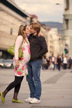 Happy and young pregnant couple have fun and relax outdoor