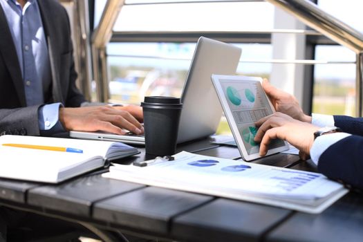 Business person analyzing financial statistics displayed on the tablet screen