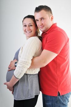 young family couple together in studio isolated on white. happy and waiting for baby