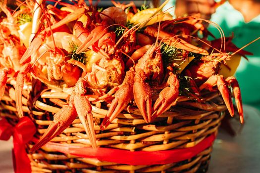 Macro stock photo of a boiled crayfish or clawfish in artificial light. Prepared lobster in close-up.