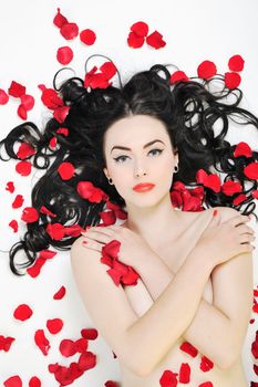 beautiful young nude woman with roses isolated on white representing beauty concept
